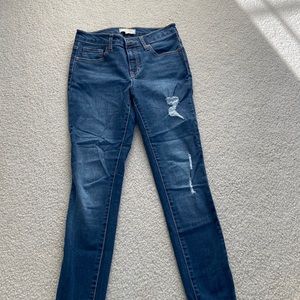 Dark wash mid-rise skinny jeans, size 25